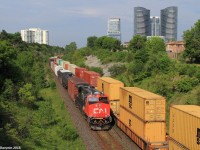 A solo shiny General Electric product is on point of a westbound manifest with some more help from a DP unit mid train. The train on the south track is eastbound intermodal train Q14891 and is a high priority intermodal which runs daily between Chicago and Montreal. It was stationary at the time with its head end just short of Doncaster Junction which is about 3 miles down the track, likely due to either a GO Transit commuter train occupying the diamond or M36921 being on the south track and needing to diverge.