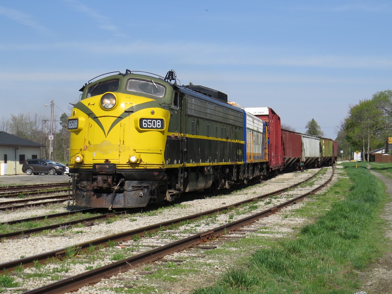 A pair of F units pull up in to the St. Thomas yard on a passing track as CN L584 works further back in the yard on the main.