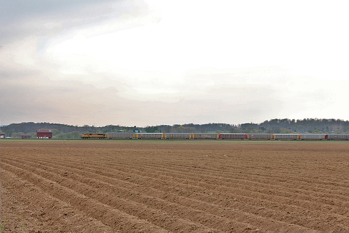 CP extra 420, or 9-420-03 is led by UP 3655 through the south end of Alliston on a somewhat overcast day in May. Autoracks make up a good percentage of the regularly scheduled 420, and there are usually a lot. Union Pacific units are also relatively common on it, and leaders aren't too rare. So, I guess a UP unit leading an extra 420 isn't too surprising. This extra is moving a bit faster than the normal 420 as it is just autoracks, 72 to be exact. It is still receiving the same treatment as the regular 420 though as it had to wait at Baxter for two and a half hours for a couple northbounds and for Spence to clear up. After finally starting to move, it is getting ready to stop again after traveling less than 6 miles. I don't nickname CP "Canadian Parking" for nothing. I can't imagine the crew was very happy about it either. However, once they drop their train at Spence, it will be swift light run to Toronto yard.