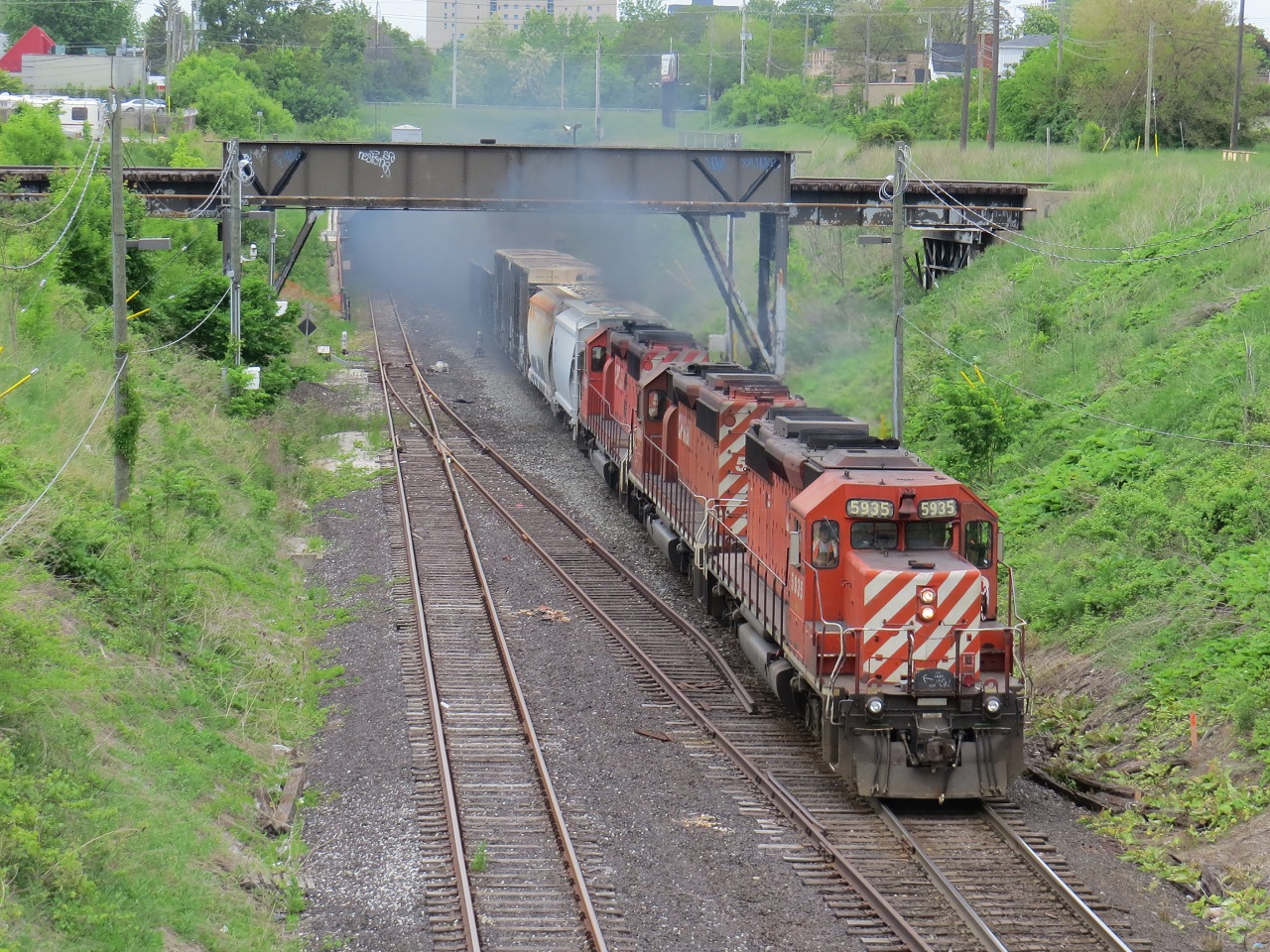 A trio of SD40-2s exit the Detroit tunnel in a cloud of smoke.