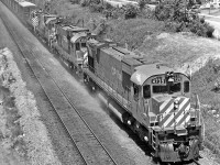 With her “Extra” flags straining, M-636 #4739 leads the charge through Scarborough, circa 1976.  Built by MLW six years earlier, the locomotive was retired in ’93, un-retired in ’94, and re-retired in ’95.
<br />
<br />
Check out Timothy Wakeman’s great shot of #4739 taken in 1987…
<br />
<br />
<a href=http://www.railpictures.ca/?attachment_id=15057>http://www.railpictures.ca/?attachment_id=15057</a>
<br />
<br />
The second and third units are a couple of C-630’s.  Both were built in 1968.  #4504 served until ’91.  #4500 lasted with the CPR until 1993.  She was then donated to the York-Durham Heritage Railway Society in Uxbridge, Ontario.  Shortly thereafter the locomotive ended up south of the 49th.   
