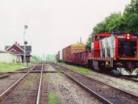 On a steamy hot July day I stopped by Merritton yard to see what was happening. Nothing. The air is thick, no breeze, and not the kind of day I wanted to hang around sweating. And besides, in the distance one can see the Welland Canal bridge is in the up position. Nice to see CN 1420 resting between jobs on the siding as perhaps the crew had taken a break for lunch; and because of that, I wandered down to the tracks for a photo. Glad I did. The 1420 is long gone from the area and the station burned down a few years after this shot was taken. As far as the 1420 goes, it had been remanufactured and renumbered from #1058 in 1989. Designated now as a GMDlu. It is still around...somewhere.