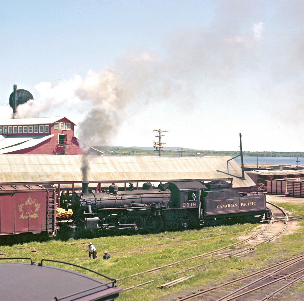 With her bell in full swing, Pacific-type #2218 works the yard at Consolidated Paper Corporation in Pembroke.  It looks like Del Rosamond has found another lofty perch for capturing an image on a hot summer’s day.