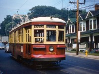 Toronto Transit Commission Peter Witt car 2728 is seen running southbound along Bathurst Street after coming down the hill to Davenport, passing streetside houses on the right and the TTC's Hillcrest Shops (out of frame) to the left. The Bathurst streetcar route was frequently home to Witts for some years. 2728 is running on the branch that ran from St. Clair Avenue south to Church Street via Bathurst, looping on Adelaide, Church and King at the south end before heading back north.