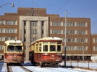 The Toronto Transit Commission needed to change their routes south of Union Station in 1961 when the Gardiner Expressway was being built. The TTC built the Ferry Loop in 1961 and used it for turning streetcars until Sept. 1965, on the site of the former Harbour Yard that used to have tracks installed to store streetcars from Eglinton Carhouse in the 50's. Pictured here, Peter Witt car 2834 (a "Small Witt" originally built by the Ottawa Car Company, signed up for the Parliament route) and newer PCC 4518 (on the Dupont route) sit at Ferry Loop, in front of the large Government of Ontario Workmans Compensation Board building in background on Harbour Street. It became the OPP headquarters in 1973, and was demolished in 2011. <br><br> By this day, the end was near for the Witt cars in regular service. The Dupont streetcar route on Bay was discontinued and replaced with buses roughly a month later, when the University subway line opened on February 28th 1963. The remaining Witts saw little service as spares for the next year or two until being officially retired on January 1st, 1965.