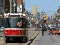 Running, Cycling, Driving, Riding. A TTC CLRV heads north on Spadina amid cyclists, pedestrians, auto traffic, and other streetcars.