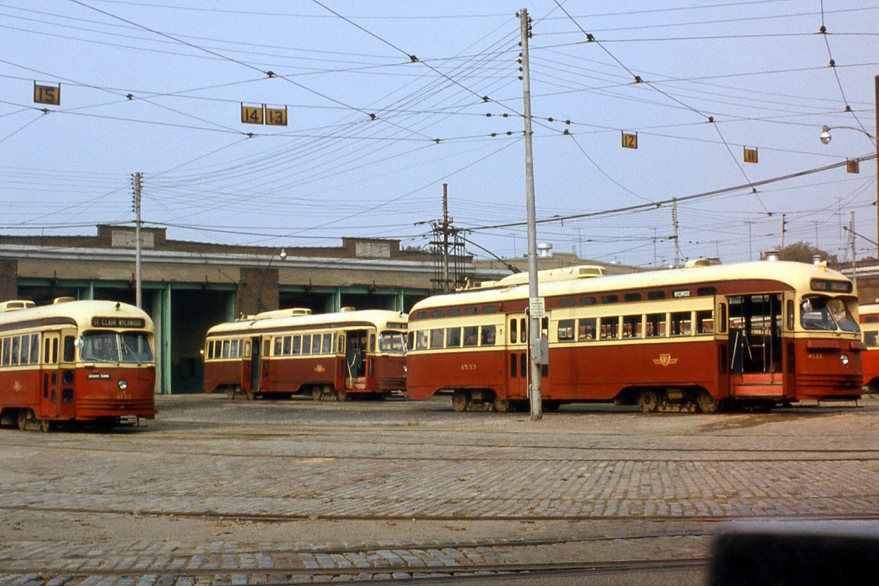 Toronto Transit Commission A-8 class PCC 4533 and two 4750-4779 series sisters (A-14 class ex-Kansas City cars) are pictured outside the Wychwood Car Barns (also known as TTC's St. Clair Carhouse) in September 1973. Built in 1914 by the Toronto Civic Railways, at the time of this photo regular operations out of Wychwood would last for a few more years before being moved elsewhere in 1978 following route consolidations. The facility served mainly as a storage yard for the TTC until it was sold to the city in 1996 (the last switches into the property were taken out of service two years later in 1998), and today has been repurposed as a community centre and park area for different events such as art shows, the summer Brewery Market, and other local events.