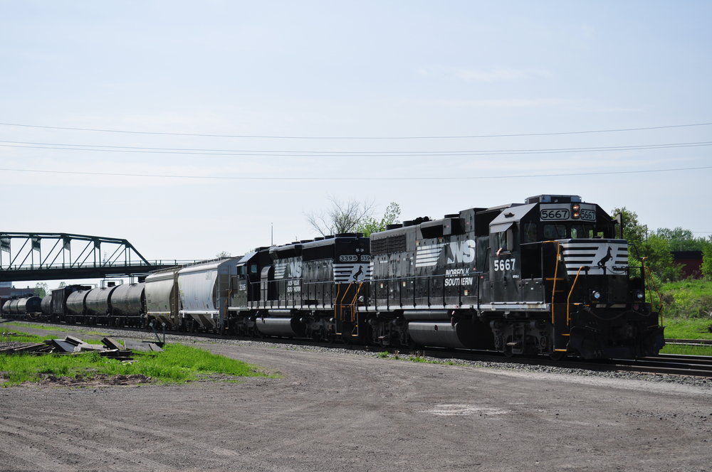 NS 369, the last NS train in Southern Ontario, waits for a train to clear off of the International Bridge, so it can get clearance to cross. The end of the train features 2 beaten up GO cars, probably dropped off by 422. If anyone knows where they were heading and the purpose of it, please let me know.