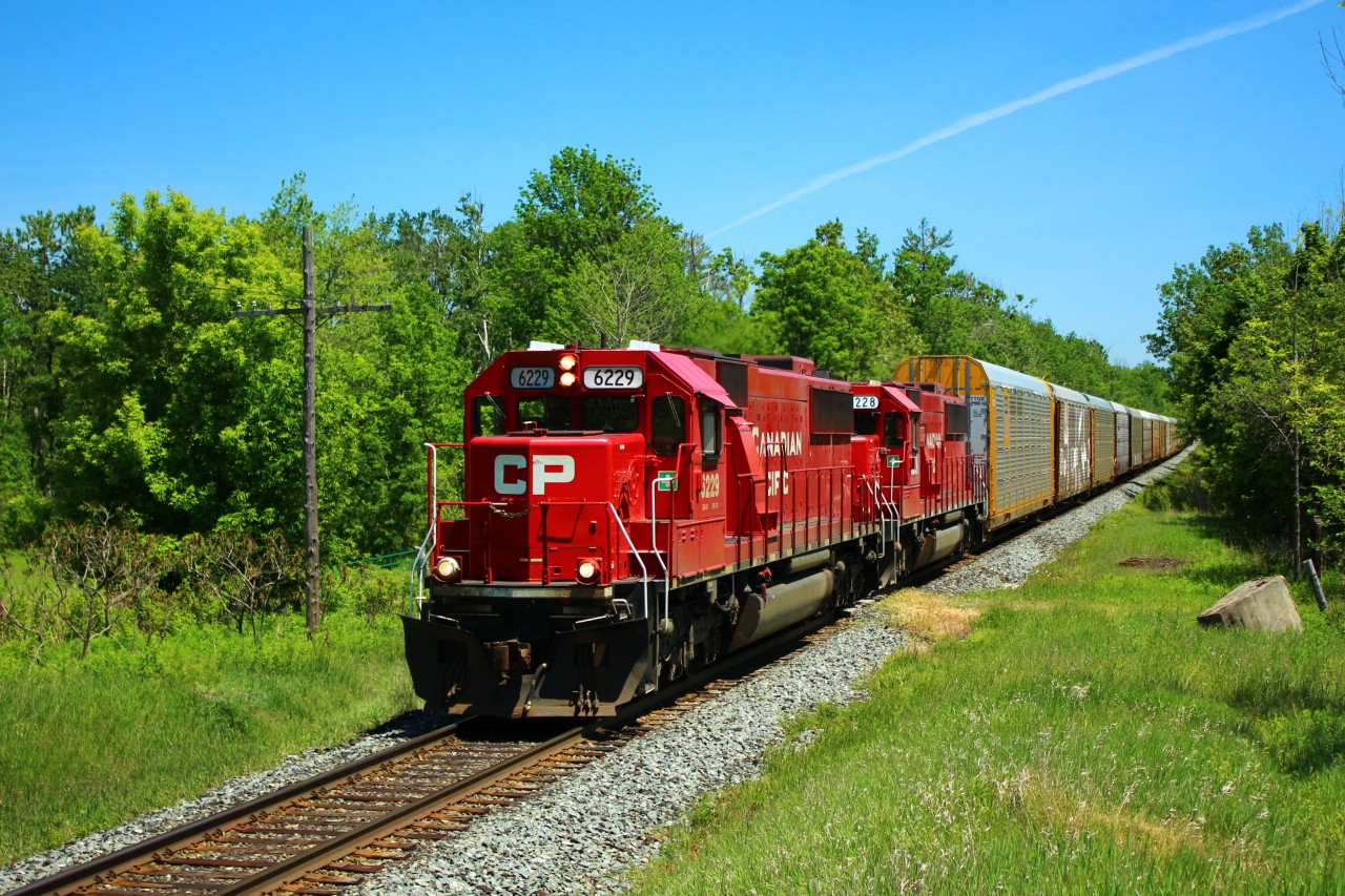 Two ex Soo engines, with shiny new paint jobs, lead CP 147 on its daily trek in to Puslinch. CP 6229 leads CP 6228 with a manifest of auto racks.