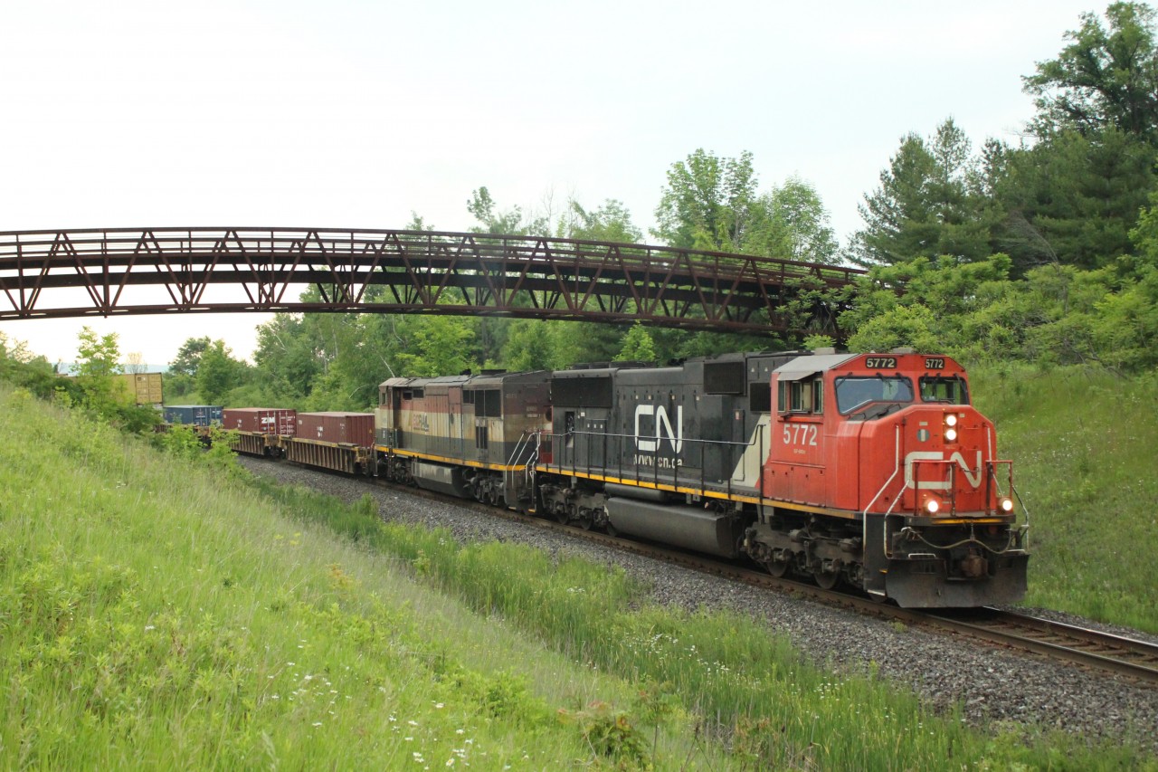 Just before the sky let loose and thunder and lightning chased me away, CN 5772 leads a very dirty BC Rail 4616 under the Glencairn GC walking bridge just before MM30.