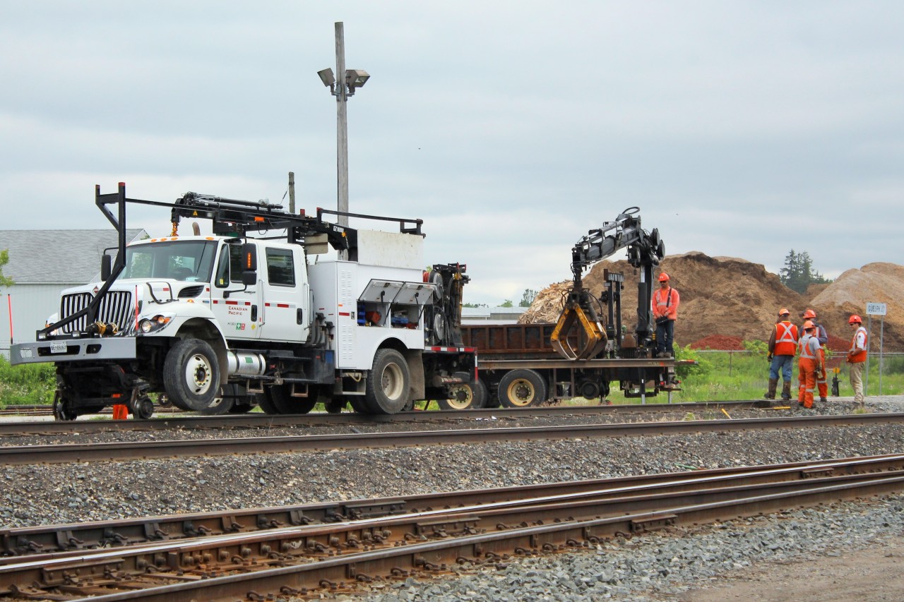 Canadian Pacific rail workers hoist a section of old rail out for replacement at Guelph Junction on the Galt sub. Hamilton Sub at bottom of picture and OSR at top.