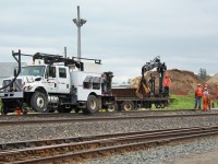 Canadian Pacific rail workers hoist a section of old rail out for replacement at Guelph Junction on the Galt sub. Hamilton Sub at bottom of picture and OSR at top.