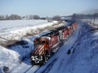 CP 5523 leading a westbound through a curve west of Woodstock on a frigid January 3, 1981.  While preparing to submit this image, I realized that although the slide was labeled Woodstock, I did not remember exactly where to locate it on the map.  Railpictures.ca's <a href=http://www.railpictures.ca/map target=_blank> map feature </a> came to my rescue.  Not only was I able to locate where it was taken but the image by James Gardiner <a href=http://www.railpictures.ca/?attachment_id=17571 target=_blank> http://www.railpictures.ca/?attachment_id=17571</a> is new enough (and mine old enough) to qualify for the <a href=http://www.railpictures.ca/time-machine> Time Machine</a> page.  An amazing amount of vegetation has popped up.