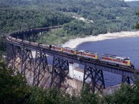 One of the scenic highlights of the Algoma Central Railroad is the bridge over the hydroelectric dam at Montreal Falls.  For our Labor Day weekend in 1981, several of us arranged with the power company for permission to drive back their private road to hang out and get a few shots at the dam. Once we were back there, one of the employees volunteered that the view was even better from on top of the little cabin they had there.  So here's a southbound freight with 2 SD-40-2's and 2 GP7L's and lot of logs on the head end crossing over the Montreal River.