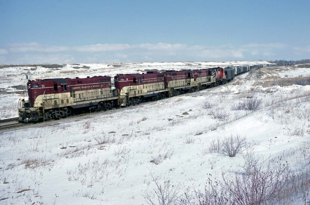 GP-7 #74 arriving into the end of the branch to Port Maitland with a sizable train on February 28, 1982.  The TH&B wasn't merged into the CP until 1987 but there was always the potential for mixed power evidenced by the RS-18 at the lashup.