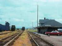 The railroads have been gone from Prince Edward Island for over 25 years. This image, like something out of the Canadian prairies, today shows not a trace of what used to be. Station, yard, trackage and outbuildings all vanished. New development is encroaching the area. It looks so nice and quaint in this photograph, not unlike the Island itself. The station appears neat and tidy, showing a lot of pride being taken in maintaining the surroundings, something we rarely see anymore. Thats probably the Agent's car parked to the side. Compared to today's offerings, it looks like a barge out of the Northumberland Strait. L-o-n-g or what? :O)