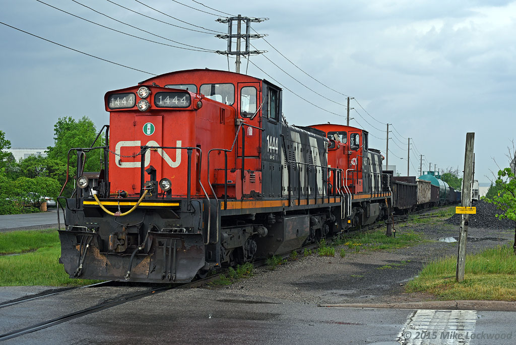 In the midst of repeated downpours, CN 1444 and 1437 switch Triple M Metals in Milton. 1536hrs.