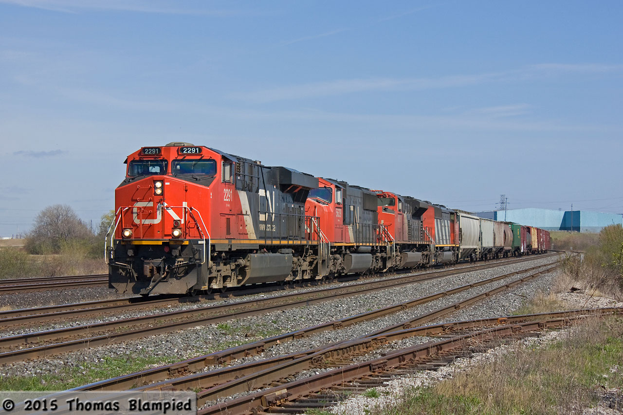 Four units lead a westbound manifest towards the South Blair Street crossing, now being rebuilt as an underpass.