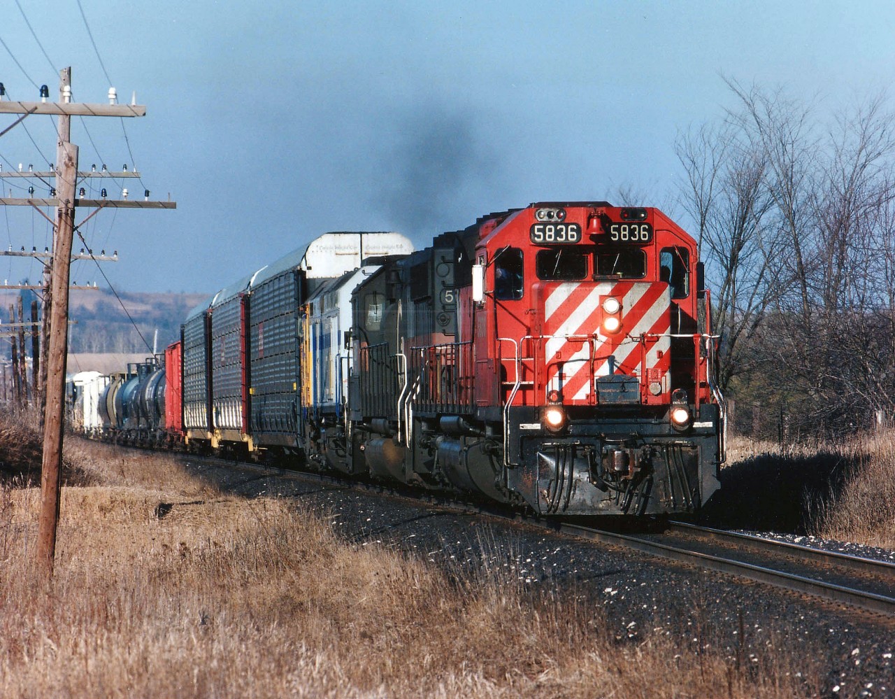 In the mid 90's, much to the delight of guys like me, the power-short CP was leasing everything they could get their hands on.  Here is an example: Westbound about to roll under the Hwy 6 bridge at Puslinch is CP 5836, HATX 501 and VIA 6452. Photo taken late afternoon.