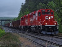 Working up grade, CP 2280 and 2288 lead 9-241's train of ballast and ties at Canyon Road in Campbellville. 1615hrs.