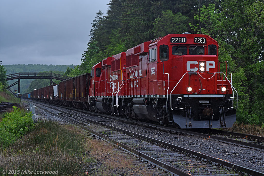 Working up grade, CP 2280 and 2288 lead 9-241's train of ballast and ties at Canyon Road in Campbellville. 1615hrs.