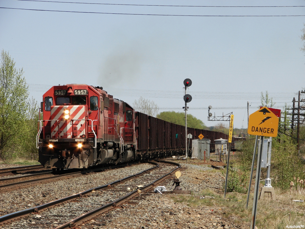 CP 5957 West diverges off the Parry Sound sub onto the Cartier sub through Romford with an empty Herzog train heading into Sudbury for another load of crushed stone. Trailing is CP GP40-2 #4656, built for Boston and Maine as #301 in 1977, currently owned by leasing company HLCX as #4222.