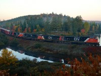 CN 368 is passing the 'Club Arlau' curve on MP 37 of the scenic Lac St-Jean Sub on its way to its destination of Chambord. Power is CN 8918, CN 2239, IC 1011, CN 2670 & CN 8004. 
