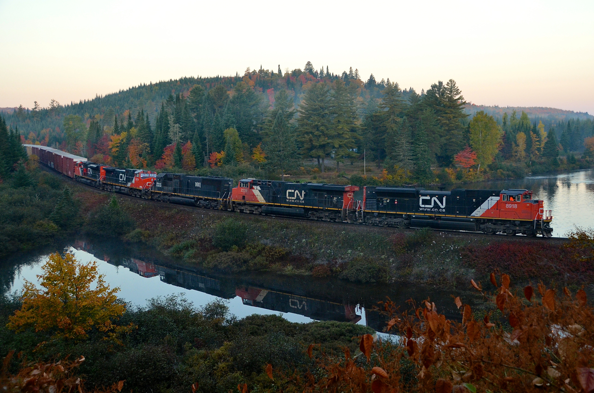 CN 368 is passing the 'Club Arlau' curve on MP 37 of the scenic Lac St-Jean Sub on its way to its destination of Chambord. Power is CN 8918, CN 2239, IC 1011, CN 2670 & CN 8004.