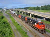 <b>More and more ES44AC's out east on CN.</b> More and more CN trains in eastern Canada have ES44AC leaders these days, and here a long CN 120 (610 axles) has older ES44AC CN 2833 and newer ES44AC CN 2940, along with SD70M-2 CN 8015 as it heads east through Turcot West.
