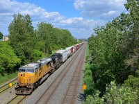 <b>Ex-UP SD90 leading.</b> CN 529 is approaching Taschereau Yard with ex-UP NS 7240 & NS 9508 on an intermittently sunny afternoon. Normally this train would have passed through here earlier in the morning, but the crew ran out of hours and the train sat in a siding on the CN Rouses Point sub for a few hours, awaiting a fresh crew to be taxied in.