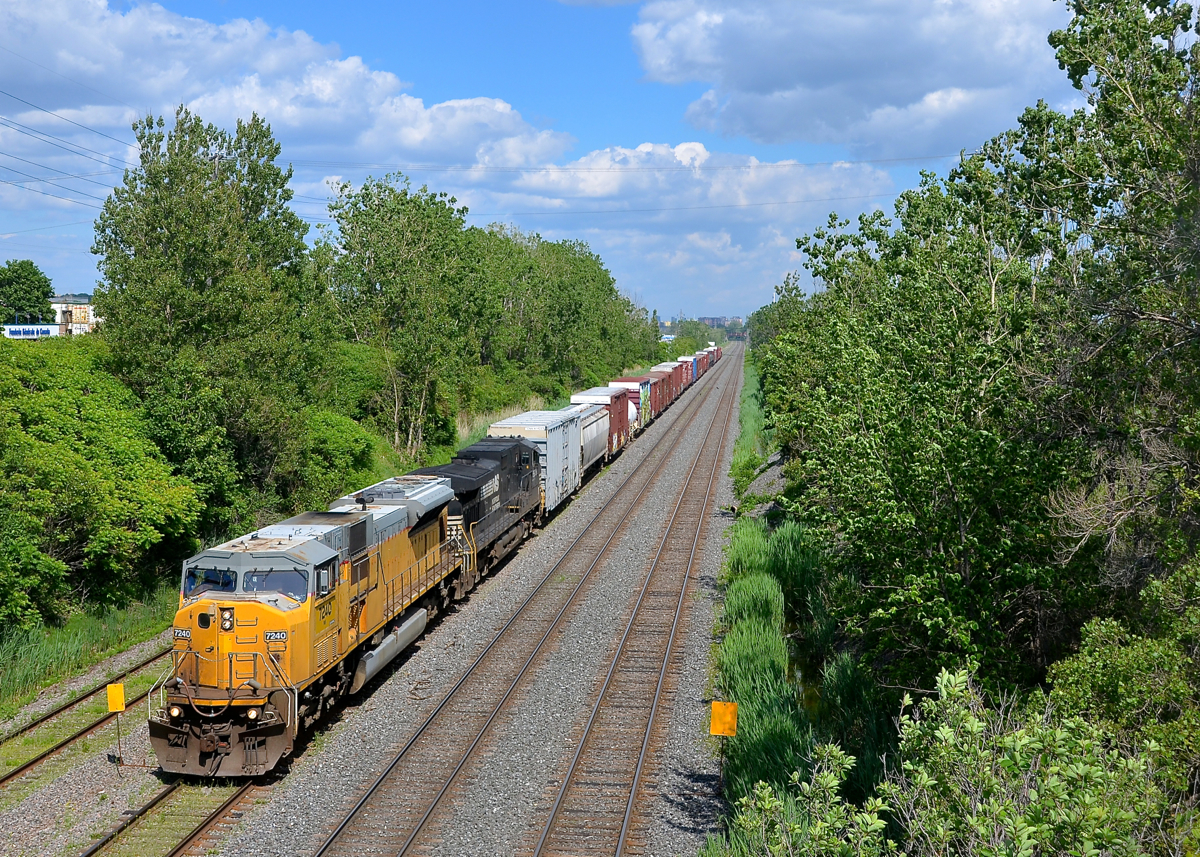 Ex-UP SD90 leading. CN 529 is approaching Taschereau Yard with ex-UP NS 7240 & NS 9508 on an intermittently sunny afternoon. Normally this train would have passed through here earlier in the morning, but the crew ran out of hours and the train sat in a siding on the CN Rouses Point sub for a few hours, awaiting a fresh crew to be taxied in.