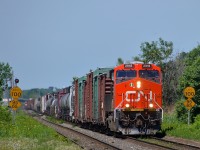 CN 368 has shiny ES44AC CN 2918 leading as it passes the speed limit signs at Dorval. Operating mid-train is older ES44DC CN 2294.