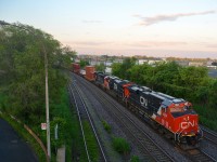 After a day of off and on heavy showers, the sky has cleared as CN 121 passes through Montreal West a bit before sunset with two ES44AC's leading an SD75I (CN 2924, CN 2865 & CN 5680).