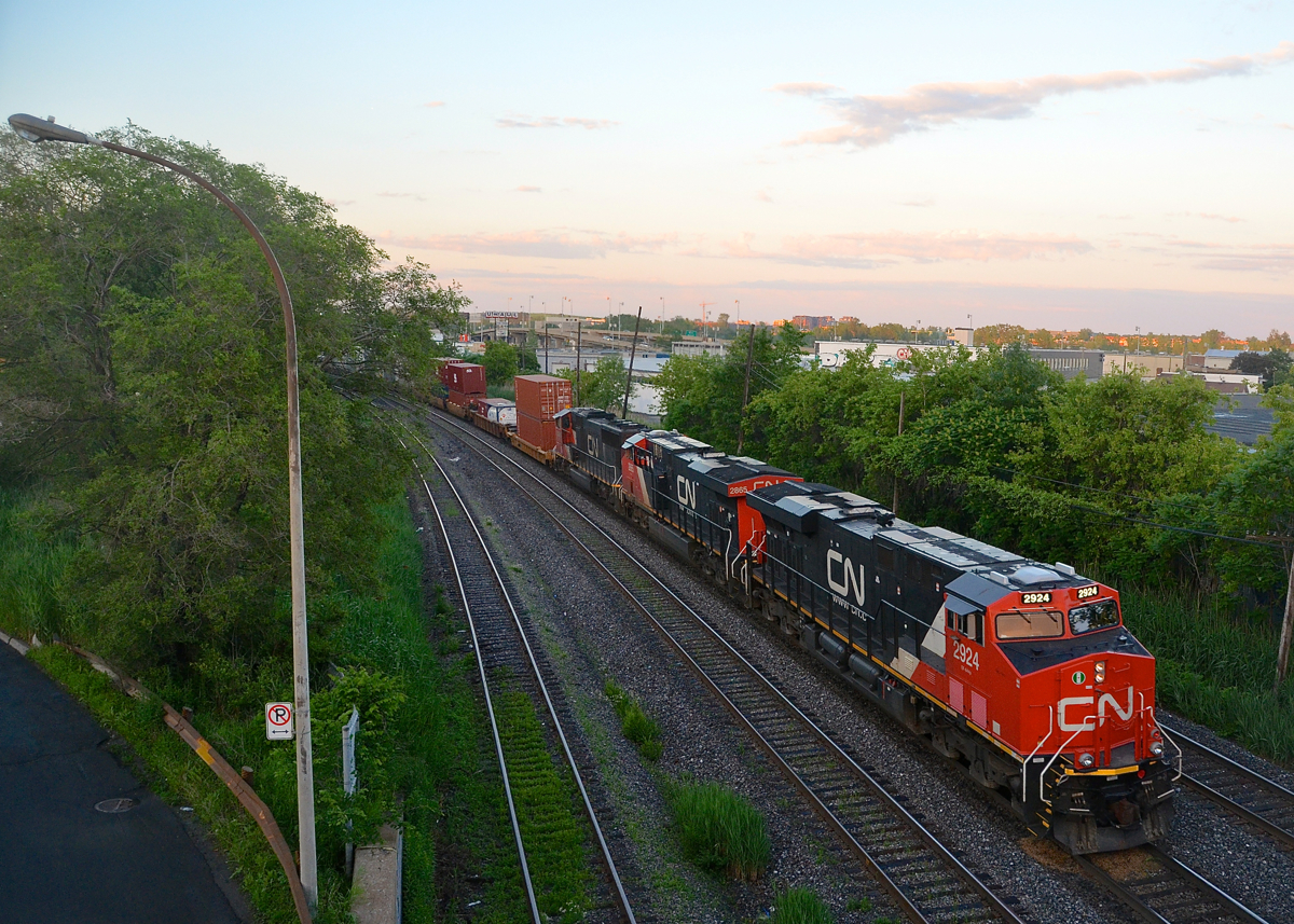 After a day of off and on heavy showers, the sky has cleared as CN 121 passes through Montreal West a bit before sunset with two ES44AC's leading an SD75I (CN 2924, CN 2865 & CN 5680).