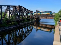 VIA 6428 & VIA 6445 back up over the Lachine canal with VIA 14 in tow on a mostly sunny evening. At the other end of the train is Park car <i>Evangeline Park</i>.