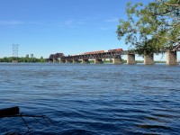 CP 8820 & CP 9804 lead CN 253 over the St-Lawrence river after waiting for the Seaway bridge to go back down after a boat passed. The Seaway bridge is visible in the distance at left.