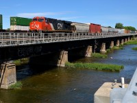 CN 377 with 188 cars total is passing through Dorion with two AC units (CN 2869 & CN 8101 mid-train). He would not make it far as a bad order car would require a setoff at Coteau. CP 143 is passing at left on the parallel CP Vaudreuil sub.