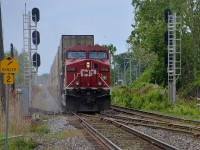 CP 112 is about to cross over at the western end of the AMT Dorval Station, and is framed by a fairly new set of signals. These signals were installed when CTC was extended along the whole length of the Vaudreuil sub; formerly this was where CTC ended for westbounds. CP 112 has about 160 cars and three GE's spread out throughout the train, with CP 9708 at the head end, CP 8896 mid-train and CP 8720 mid-train even further back. He is crossing over so that he can enter Lachine IMS in a couple of miles.