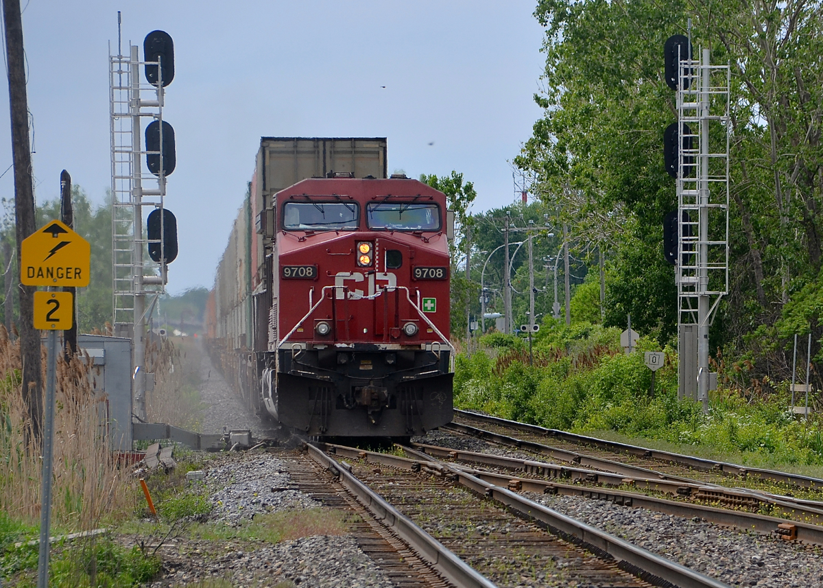 CP 112 is about to cross over at the western end of the AMT Dorval Station, and is framed by a fairly new set of signals. These signals were installed when CTC was extended along the whole length of the Vaudreuil sub; formerly this was where CTC ended for westbounds. CP 112 has about 160 cars and three GE's spread out throughout the train, with CP 9708 at the head end, CP 8896 mid-train and CP 8720 mid-train even further back. He is crossing over so that he can enter Lachine IMS in a couple of miles.