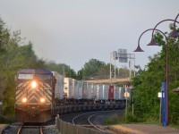 CEFX 1058 leads CP 133 around a curve just before Valois station. Trailing is CP 9680.