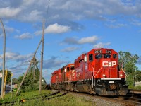 <b>An SD40-2 sandwich and a wave from the engineer.</b> CP 133 (the Expressway) is through Dorval with an all-EMD lashup which consists of an SD40-2 sandwiched by two much nwer GP20C-ECO's (CP 2276, CP 5935 & CP 2250) as the conductor waves from the lead unit