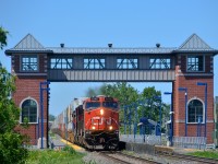 <b>CN 120 past an unusual looking station.</b>CN 120 is passing the unique looking Saint-Basile-le-Grand AMT commuter station with CN 2240, CN 2500, CN 2303 & CN 5745 as power.