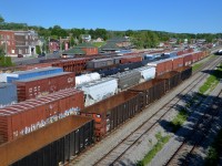 The St. Lawrence and Atlantic Railroad yard in Richmond is rather full in this shot. CN 394 is about to arrive from Montreal and after dropping off his train he will pick up three of these tracks and head back to Montreal as CN 393 with 99 cars. In the background is the ex-Grand Trunk station. Richmond was once an important centre on the Grand Trunk, with tracks heading north to Quebec City and southeast to Portland, Maine.