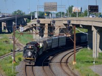 <b>A death star leader through Turcot West.</b> A later than usual CN 310 has an IC SD70 leading (IC 1015) as well as another as DPU (class leader IC 1000) as it passes through Turcot West with 694 axles. It will drop off the trailing unit (CN 2031) and some cars at Southwark yard before continuing onto Joffre yard near Quebec City.