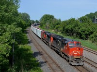 CN X324 has CN 2185 & CN 8843 has 236 axles as it heads east just out of Taschereau Yard. He will pick up some cars at Southwark Yard and then head to St. Albans, VT for interchange with the New England Central Railroad.