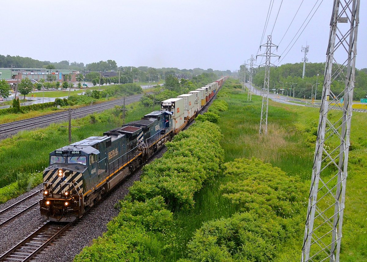 Back to back BC Rail in the rain. I got up to this overpass in the pouring rain after chasing CN 149 with just a couple of seconds to change my settings and then get a quick wide shot. Worth getting wet for my first solid set of BC Rail units! CN 149 is seen roaring through Pointe-Claire with BCOL 4646 & BCOL 4651 for power.
