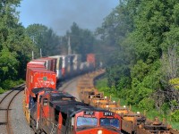 A trio of Dash9's (IC 2717, CN 2699 & CN 2636) lead CN 120 around a curve on the Montreal sub. The third unit is isolated so the other two are smoking it up in true GE fashion.