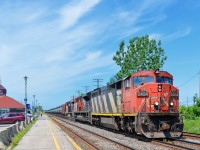 <b>Class lights lit = check.</b> CN 720 has a nice zebra striped cowl leading (CN 2404) with its green class lights lit as it passes through the VIA Dorval station. Trailing are CN 8918 & CN 2298. CN 720 is a crude oil train bound for Rivière-des-Prairies in east end Montreal.