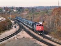 Off work early on this particular Saturday, so, being then a foaming rail rat, of course wandered over to Bayview to see what was happening. An extra was on the way eastbound, billed as a "Director's Special", so waited it out. As seen from the lookout at former Hamilton West, CN 9506, with extra flags, has six coaches in tow, interesting variety.........that looks to be the Observation car on the end; huge window in order the big wigs can watch the miles roll by..........Six cars.....kinda means the railroad was a tad management heavy back then, wouldn'cha think? All those boys going for a free ride :o) (The 9506 went to the Massachusetts Bay Transit Authority in 1995)