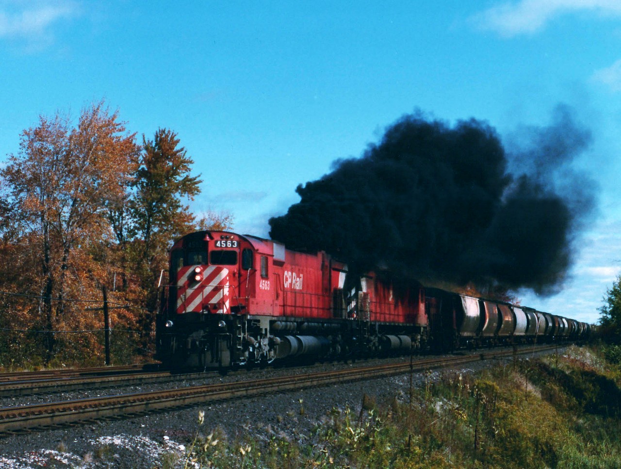 Doing its' very best impression of the Iron Horse, CP 4563 steams...er..smokes its way out of Guelph Jct westbound. Trailing is 4720, and, hidden in the shadows is CP 7064, an old Alco S-2. One could assume this relic was probably heading for retirement. Photo taken from the side of First Line, once a gathering spot for CP fans, now gone quiet due to infestation of "No Parking" signs.
